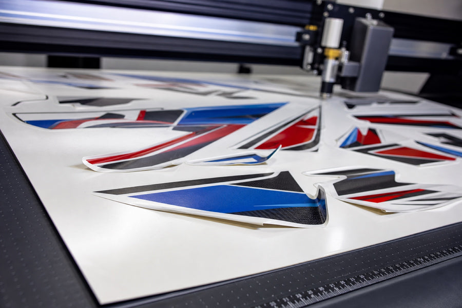 Kiss-cut motorsport decals lifting at corners on a cutting plotter