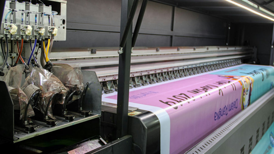 Wide-format printer producing a large-format graphic in a print shop